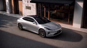 Silver 2026 IM L6 electric sedan outside a café, front three-quarter view